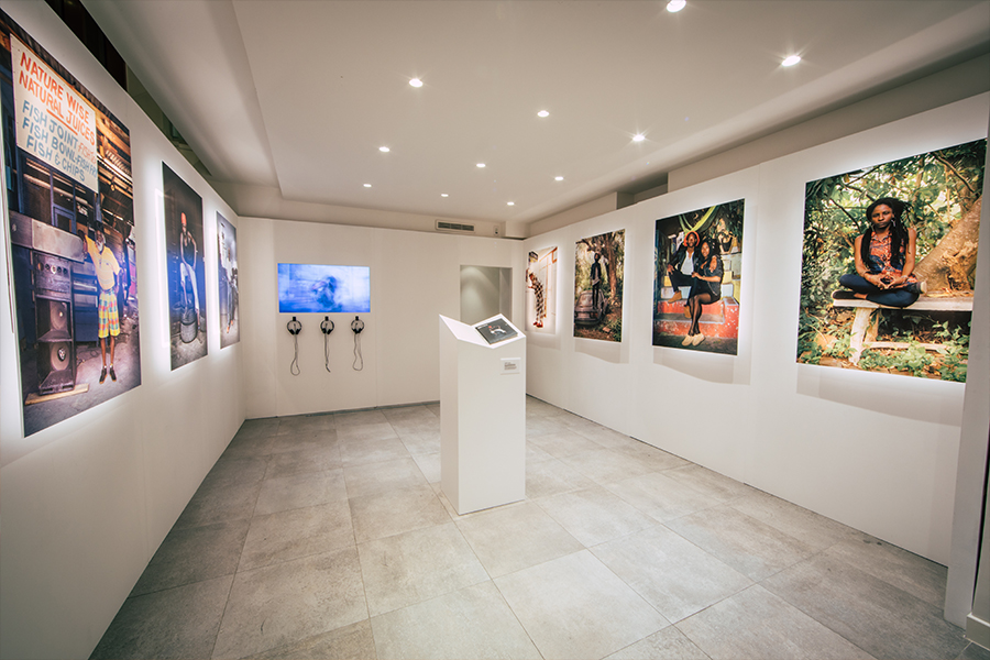 Showroom from Clarks at Paris Fashion Week with prints showcasing the brands link to Jamaican street culture on each wall.