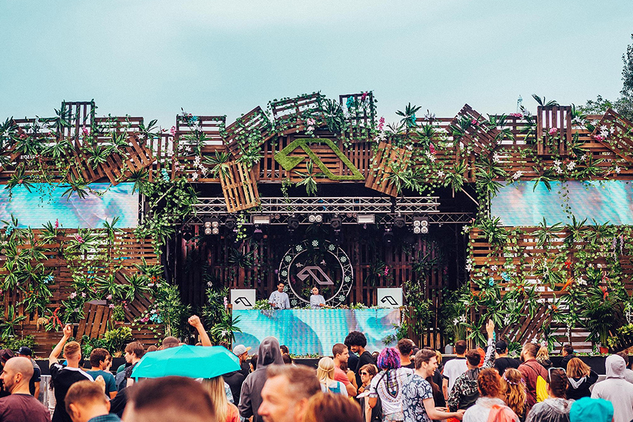 Main stage at Anjunadeep electronic music festival, designed with wooden pallets and foliage 