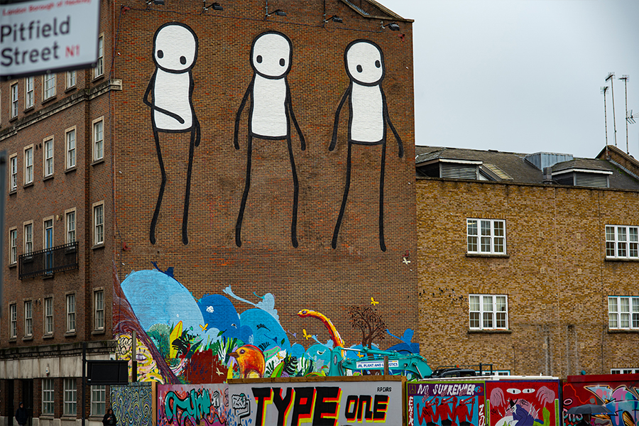 stick men graffiti drawing on brick wall in shoreditch east london