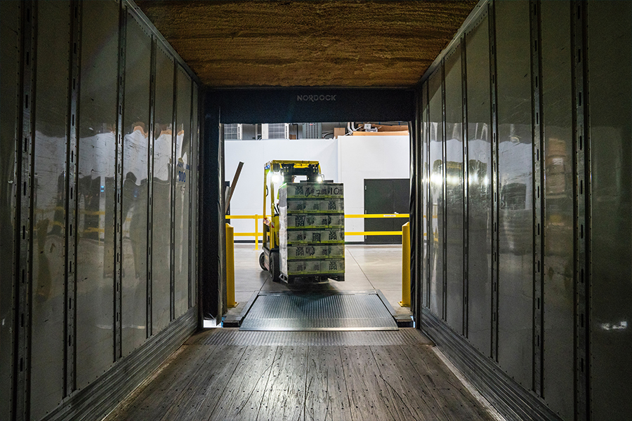 Forklift truck driving a delivery into a truck